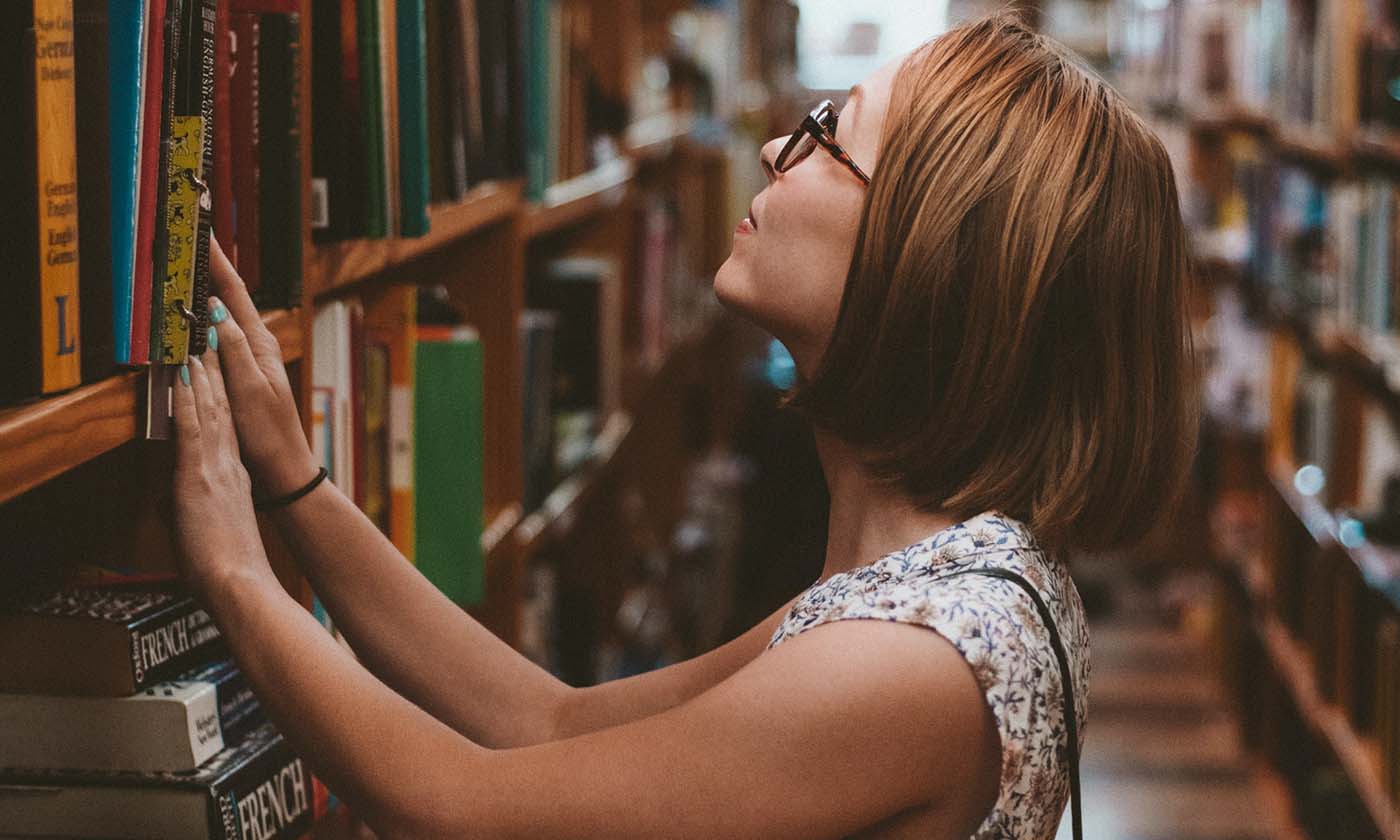 A woman browses books at the library